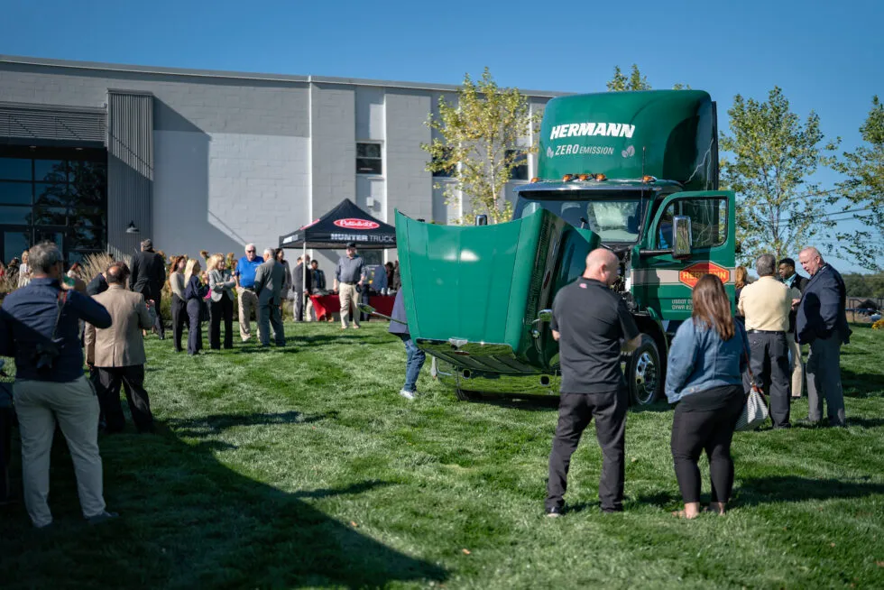 Guests admiring Peterbilt 579EV at Hermann Services event