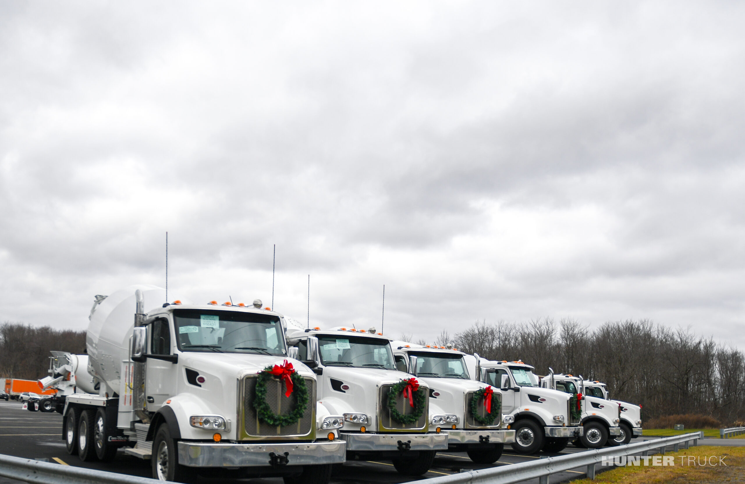 White Peterbilt Cement trucks with holiday wreaths 