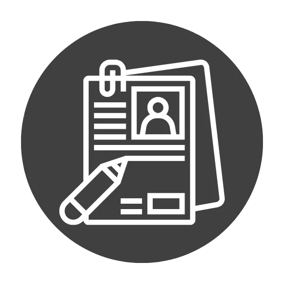 Young man, a peterbilt mechanic at hunter truck, stands in front of a peterbilt in a service bay.