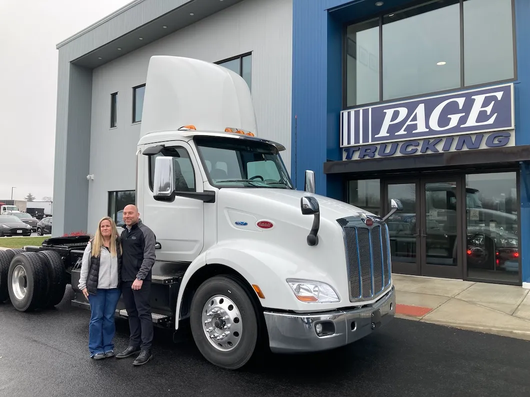 Page Trucking group photo in front of the Peterbilt 579 EV