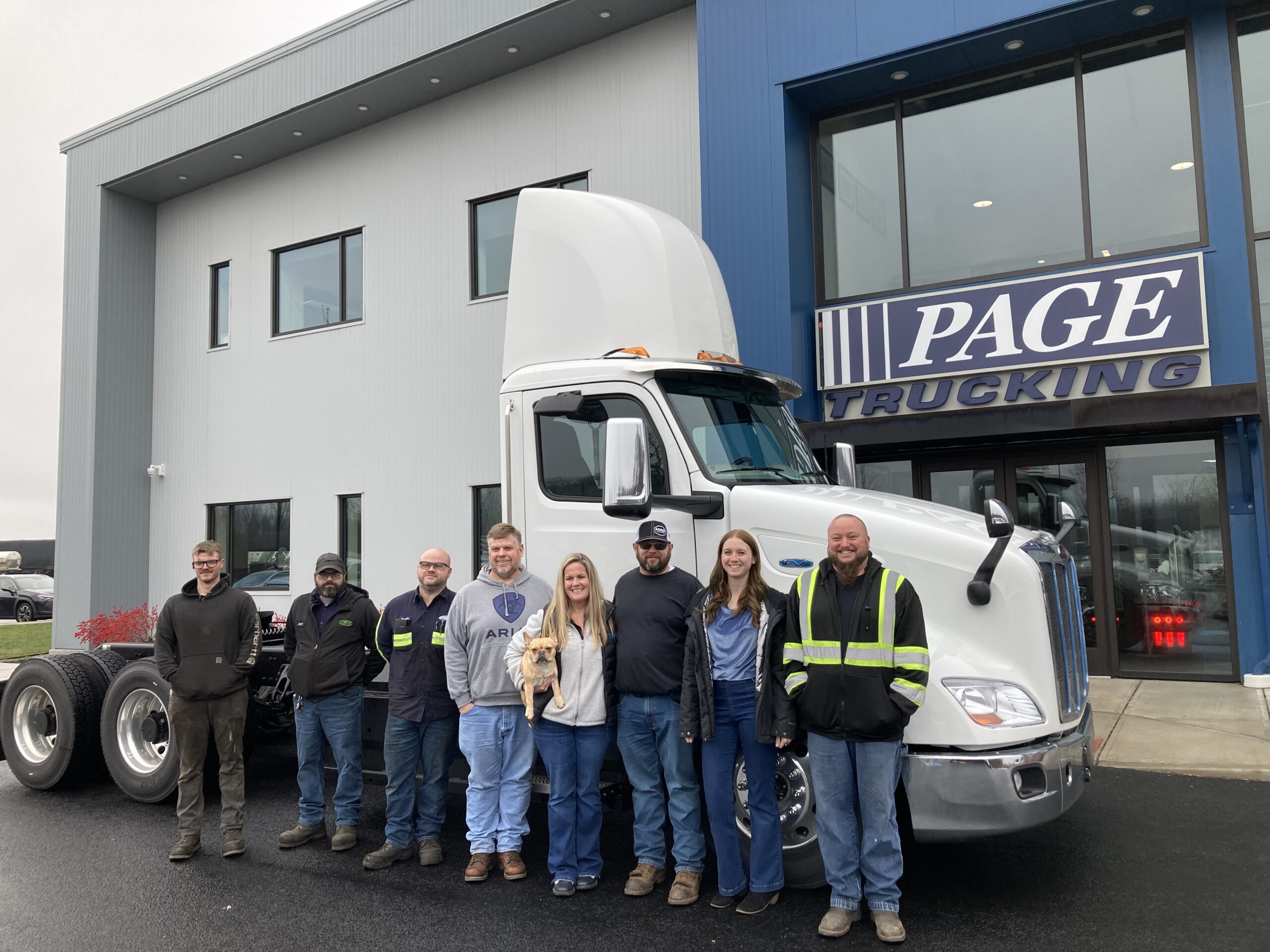 Page Trucking group photo in front of the Peterbilt 579 EV